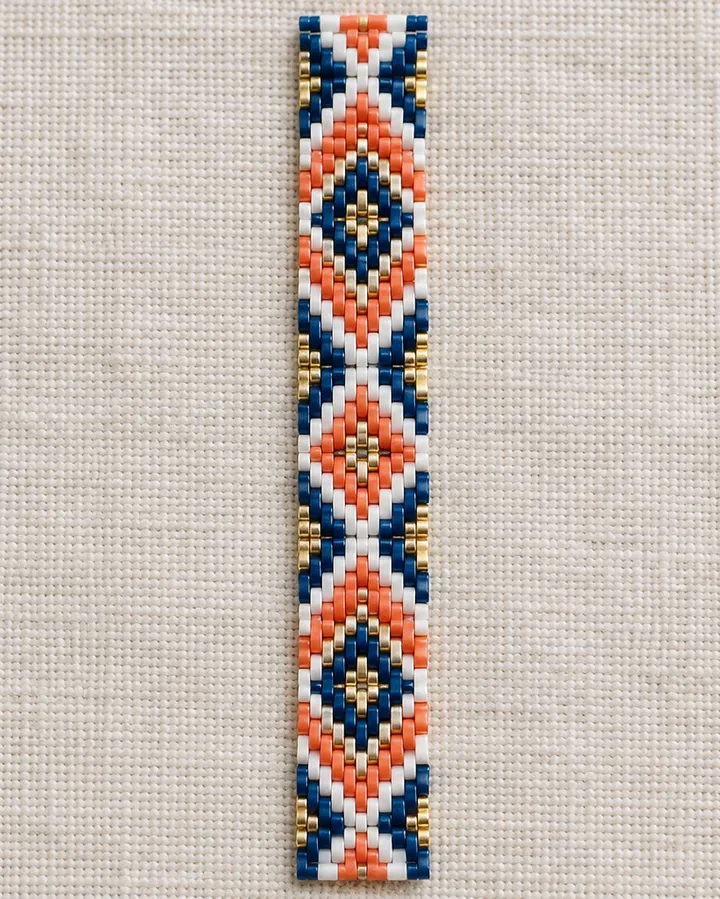 Flat peyote bracelet band with a diamond motif in navy, coral, gold and white Miyuki Delica beads